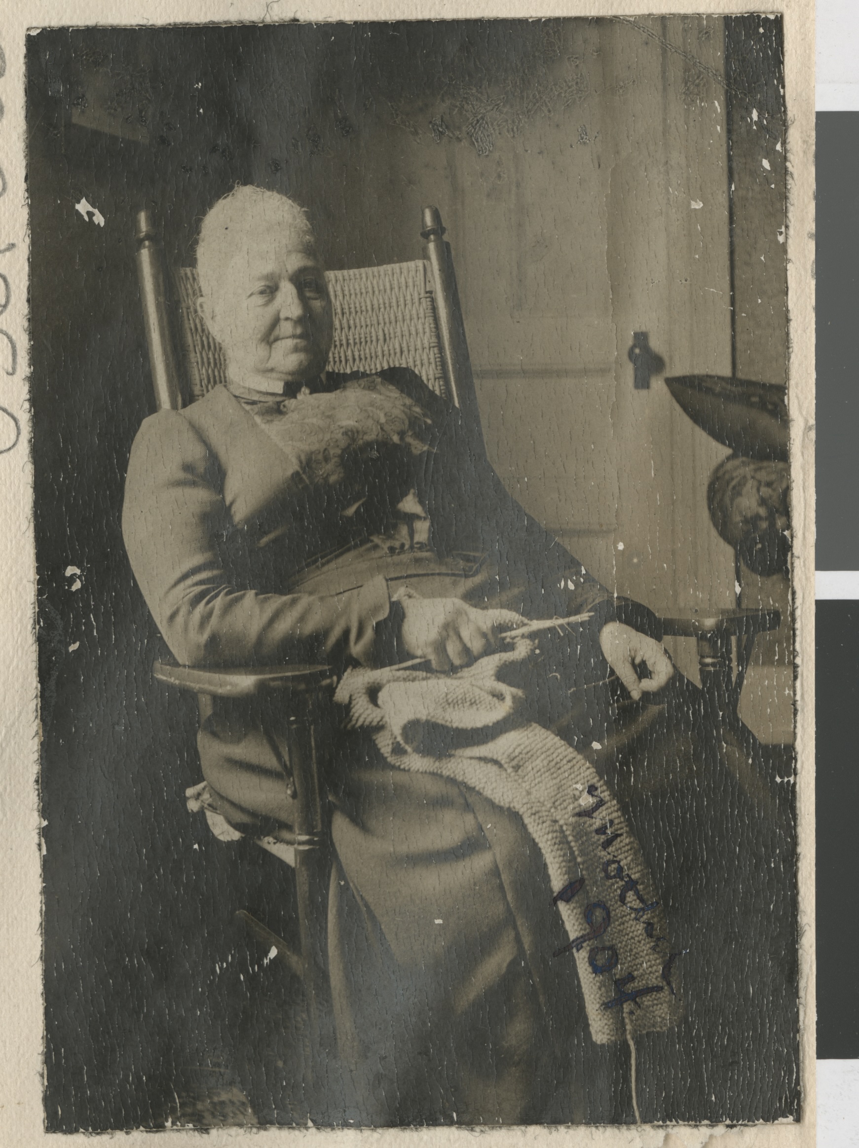 Photograph of a woman with knitting, sitting in a chair, 1904