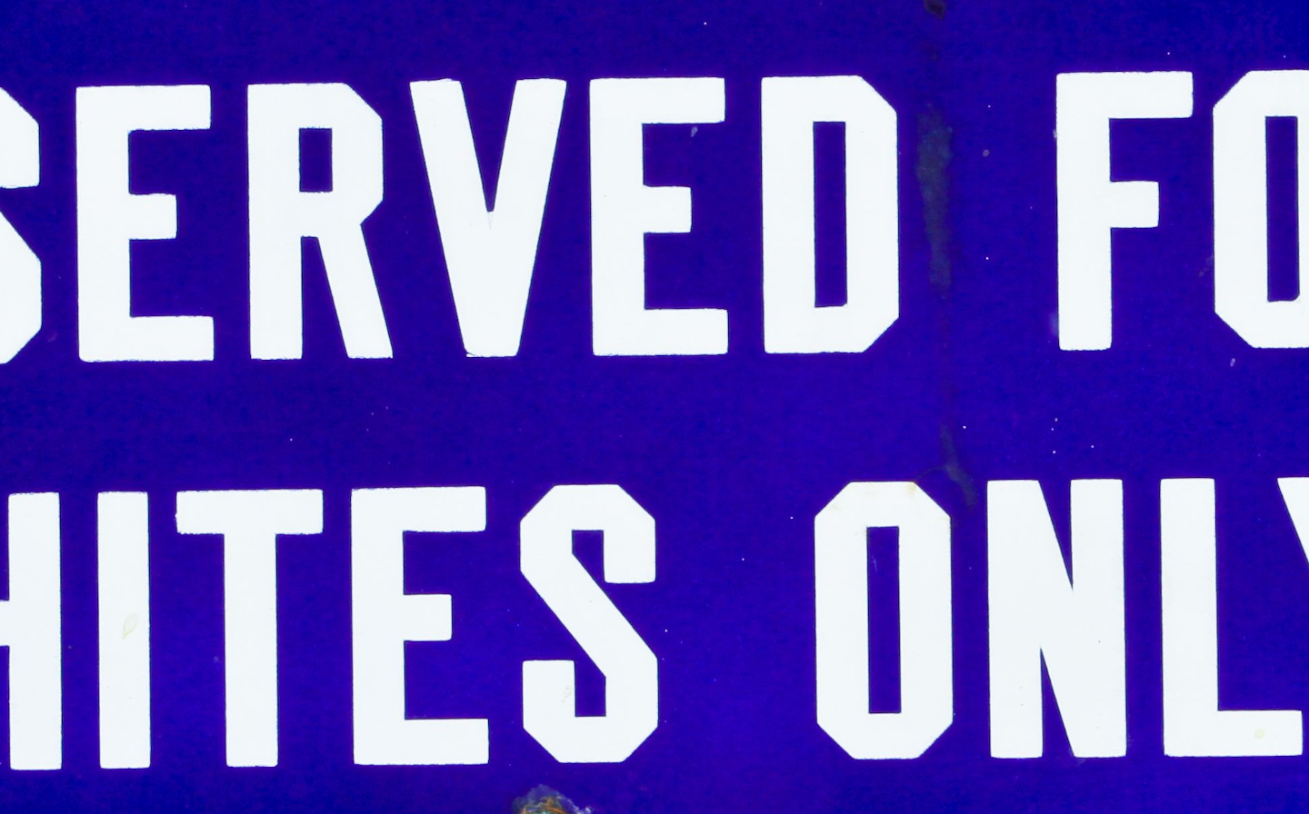 A “whites only” restroom sign