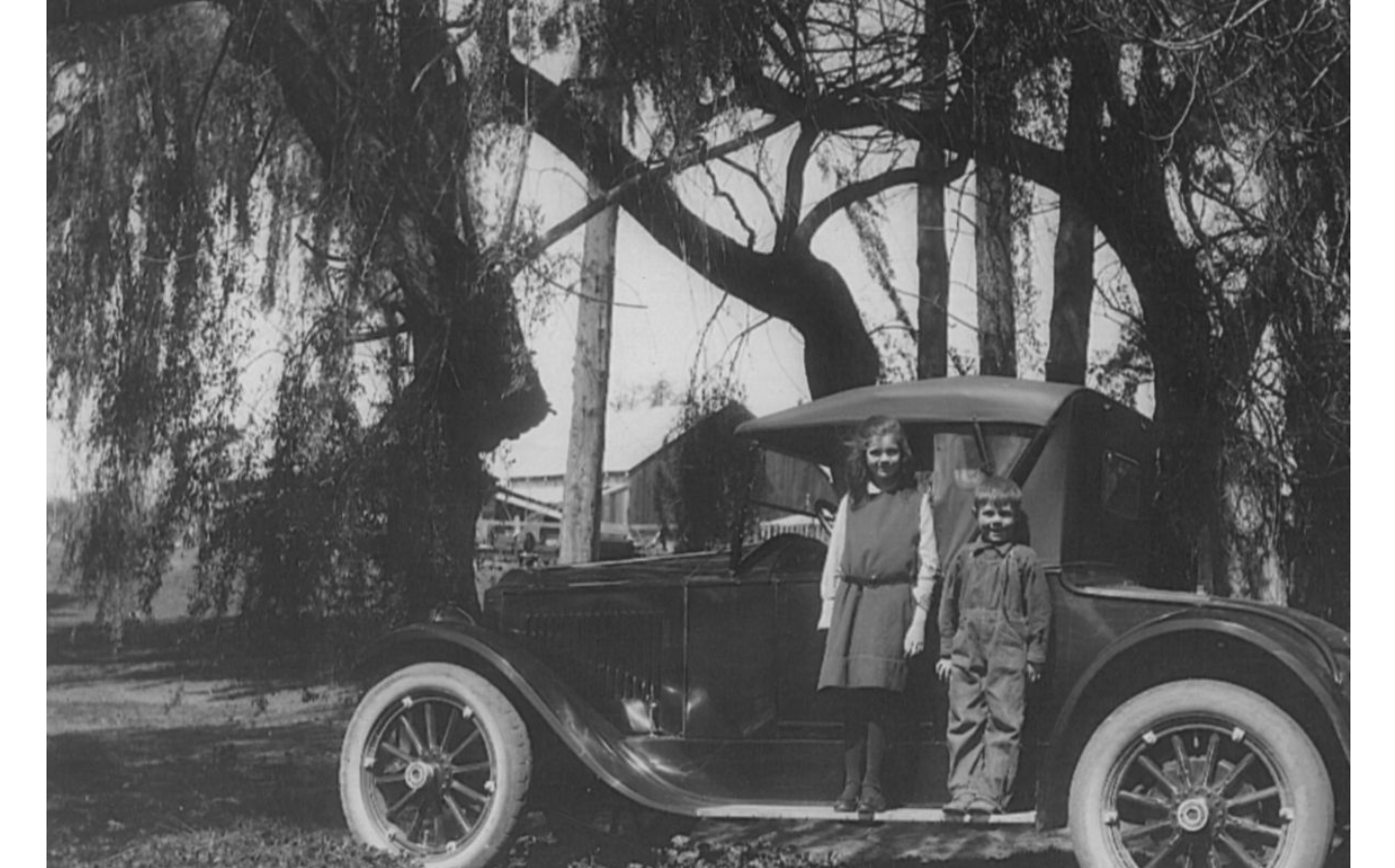 A photograph of kids and a new car